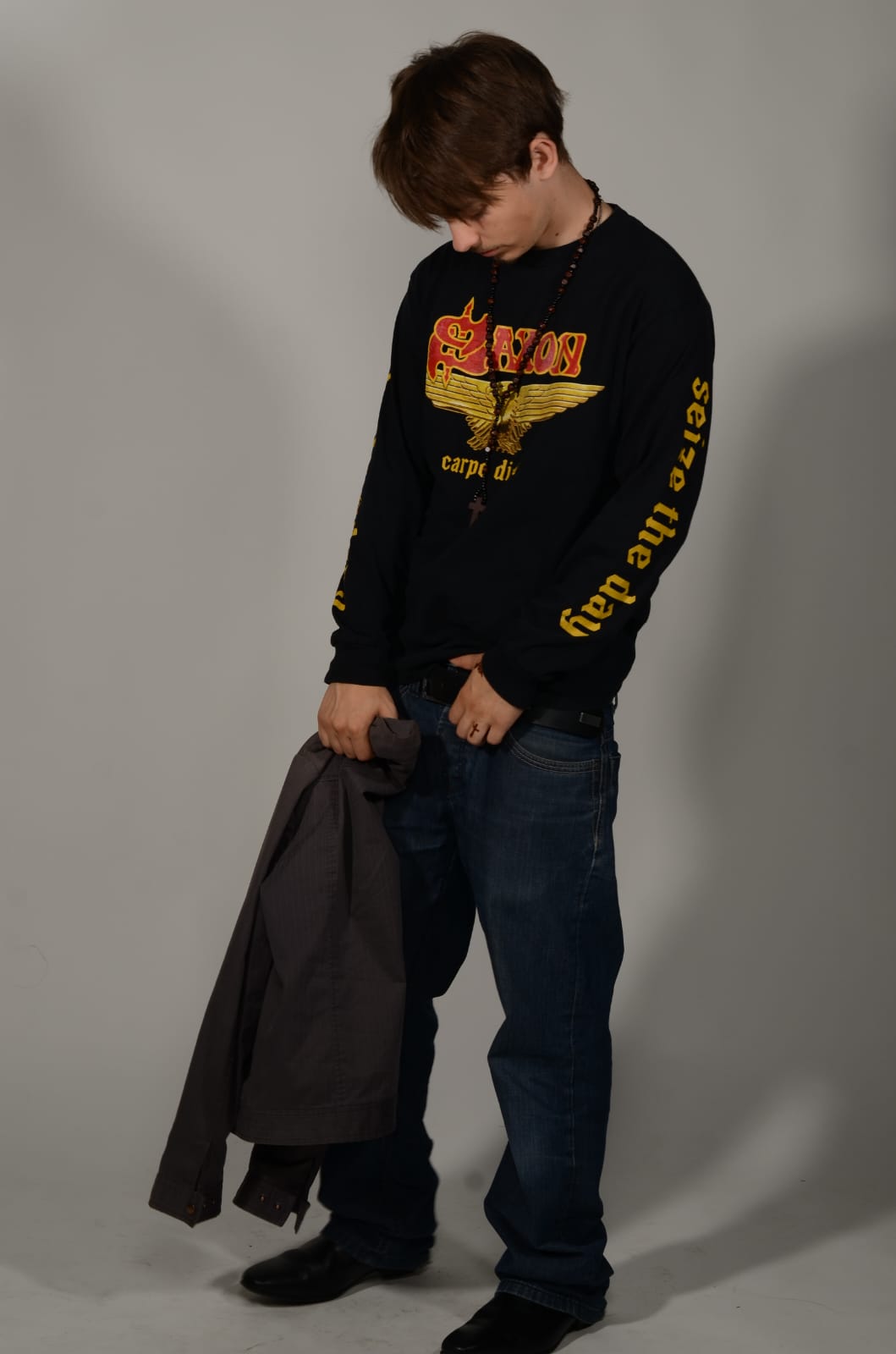 Frank Studley holding a jacket and looking down